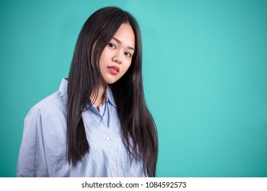 Asian Neighbour Girl, Looking At Camera Isolated On Studio Blue Background, Copyspace For Your Message