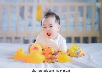 Asian New Born Baby Sit And Play An Animal Toy On The Bed, Boy, Kid, Baby, Play And Relax Concept