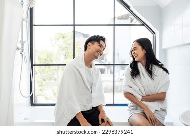 Asian new marriage couple spending time together in bathroom at home. Attractive young man and woman feeling happy and relax, enjoy holiday honeymoon anniversary day then looking each other in house. - Powered by Shutterstock