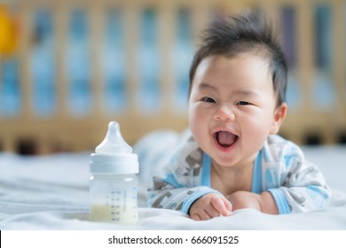 Asian Newborn baby smile with milk power bottle, baby, boy, mom, mother concept