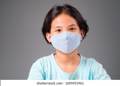 Asian Nine Years Old Girl Wearing Hygienic Cloth Mask To Prevent The Virus