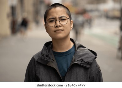 Asian Non-binary Woman Serious Angry Face Portrait On A City Street