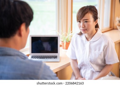 Asian Nurse Apologizing With Male Patient