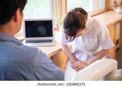 Asian Nurse Apologizing With Male Patient