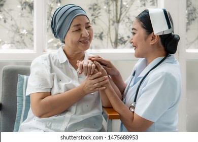 Asian Nurse Gentlely Hug Senior Cancer Patient Who Wearing Headscraf After Chemotherapy To Encourage Patein To Fight With Sickness