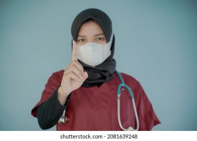 Asian Nurse Hijab Wearing Face Mask Rising Finger 