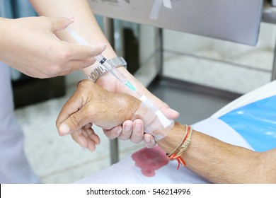 Asian Nurse Inject At Patient's Arm For Intravenous Fluid 