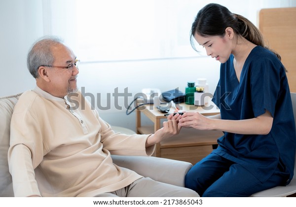 Asian\
nurse in nursing home examine pulse and blood sugar for old man by\
blood sugar check measuriment for check\
diabetes
