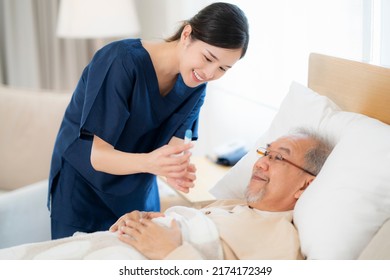 Asian Nurse In Nursing Home Support Old Man For Check Temperature By Thermometer After He Sick From Faver And Come Back From Hospital