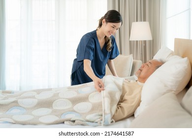 Asian Nurse In Nursing Home Support Old Man For Sleeping On The Bed In Patient Room