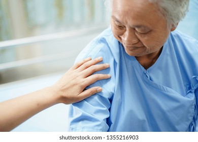 Asian Nurse Physiotherapist Doctor Touching Asian Senior Or Elderly Old Lady Woman Patient With Love, Care, Helping, Encourage And Empathy At Nursing Hospital Ward : Healthy Strong Medical Concept.
