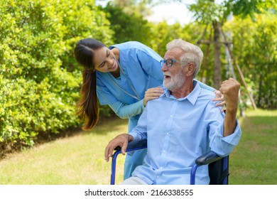 Asian Nurse Sitting On A Hospital Bed Next To An Older Man Helping Hands Care In Garden At Home. Elderly Patient Care And Health Lifestyle, Medical Concept.