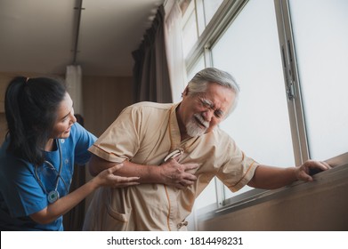 Asian Nurse Support Old Male Patient With Heart And Chest Pain While Standing Near The Window After Treatment At Hospital