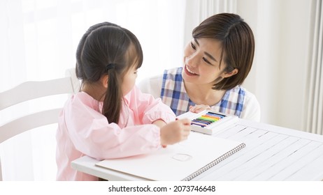 Asian Nursery Teacher And Child