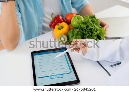 Asian nutritionist using tablet to explaining personalized meal plan with AI to patient during healthcare consultation, healthy lifestyle, woman dietitian showing nutrition plan with AI on tablet.