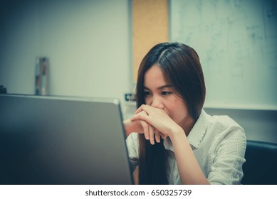 Asian office woman stress from work at the desk with laptop