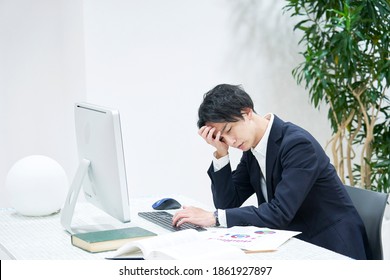 Asian office worker being tired - Shutterstock ID 1861927897