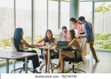 Asian Office Worker Sitting In A Relaxed Meeting At Work.