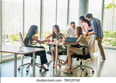 Asian Office Worker Sitting In A Relaxed Meeting At Work.