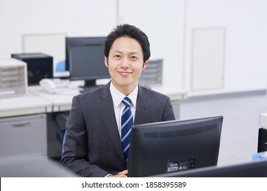 Asian office worker smiling at the office
