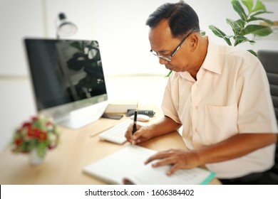 Asian Old Business Man Working In The Office With Computer 