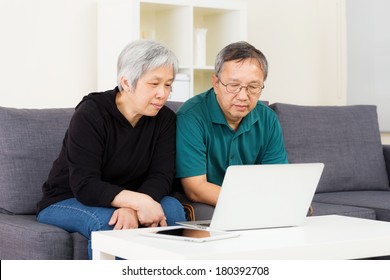 Asian Old Couple Using Laptop