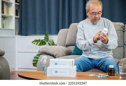 Asian old man buy herbal self cure Rx pill online from pharmacy, worried senior man with medicine pills he read on see how to take pills before taking, home isolation, Medical service concept - Powered by Shutterstock