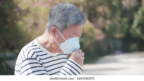 asian old man coughs and wear protective mask because of transmissible infectious diseases or hay fever outdoor - Powered by Shutterstock