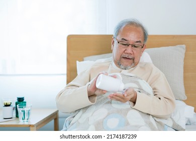 Asian Old Man Eating Drug On The Bed At Home, This Photo Can Use For Drug, Medicine, Pharmacy And Insurance Concept