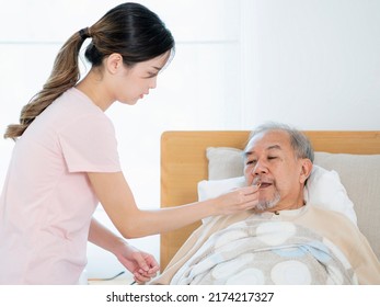 Asian Old Man Eating Drug On The Bed At Home, This Photo Can Use For Drug, Medicine, Pharmacy And Insurance Concept