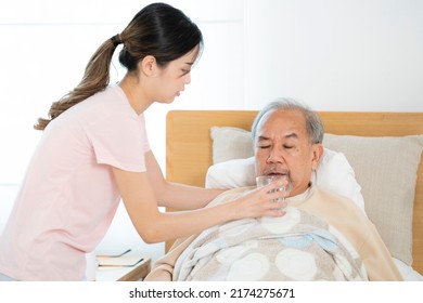 Asian Old Man Eating Drug On The Bed At Home, This Photo Can Use For Drug, Medicine, Pharmacy And Insurance Concept