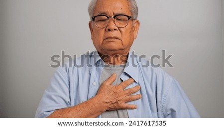 Asian old man has difficulty breathing. An elderly man has dyspnea.