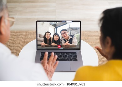 Asian Old Senior Couple Video Call Virtual Meeting Via Computer Laptop With Family