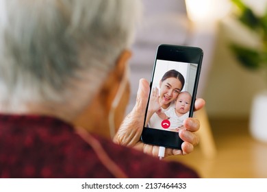 Asian Old Senior Making Video Call Via Mobile Phone Talking With Family