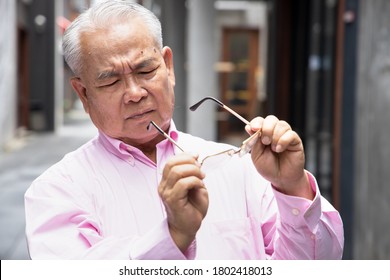 Asian Old Senior Man Suffering From Presbyopia, Long Sight Or Loss Of Sight With Blurry Vision