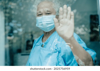 Asian Old Senior Woman Patient With Mask Looking Out The Window To Quarantine During Covid19 Coronavirus Pandemic, Stay At Home.