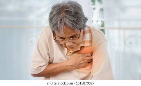 Asian Old Woman With Chest Pain Suffering From Heart Attack At Home