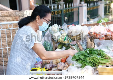 Asian old women shop cooking ingredients in mobile traditional seller