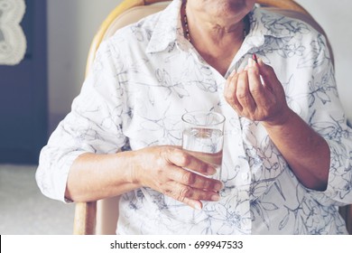 Asian Older Elderly Woman Are Taking And Eating Vitamins Medicine And Drink Water For Help Sick And Healthy.
