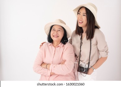 Asian Older Woman And Her Daughter On White Background, Travel Concept 