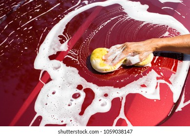 Asian Oldman Using Yellow Sponge Washing New Red Car. Cleaning Background. Top View With Copy Space.