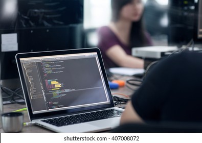 Asian Outsource Developer Team Sitting At Desk Working Laptop Computer Mobile Application Software Real Office - Powered by Shutterstock