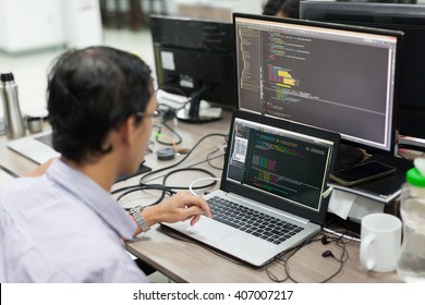 Asian Outsource Software Developer Looking Screen Sitting At Desk Working Laptop Computer Mobile Application Software Real Office 