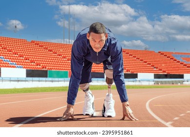 Asian para-athlete with prosthetic blades leg in stadium practicing workout for running competition. Amputee sports man runner practicing running workout. Disabled athlete man sport concept. - Powered by Shutterstock