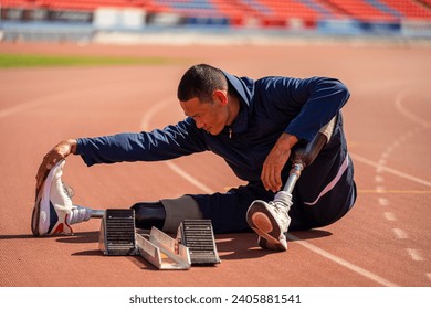 Asian para-athlete runner prosthetic leg on the track training alone outside on a stadium track Paralympic running concept. - Powered by Shutterstock