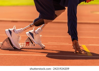 Asian para-athlete runner prosthetic leg on the track alone outside on a stadium track Paralympic running concept. - Powered by Shutterstock