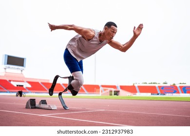 Asian para-athletes disabled with prosthetic blades running at stadium. Attractive amputee male runner exercise and practicing workout for Paralympics competition regardless of physical limitations. - Powered by Shutterstock