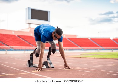 Asian para-athletes disabled with prosthetic blades running at stadium. Attractive amputee male runner exercise and practicing workout for Paralympics competition regardless of physical limitations. - Powered by Shutterstock - Get 15% off with code: PIKWIZARD15