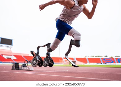 Asian para-athletes disabled with prosthetic blades running at stadium. Attractive amputee male runner exercise and practicing workout for Paralympics competition regardless of physical limitations. - Powered by Shutterstock