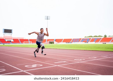 Asian para-athletes disabled with prosthetic blades running at stadium. Attractive amputee male runner exercise and practicing workout for Paralympics competition regardless of physical limitations - Powered by Shutterstock